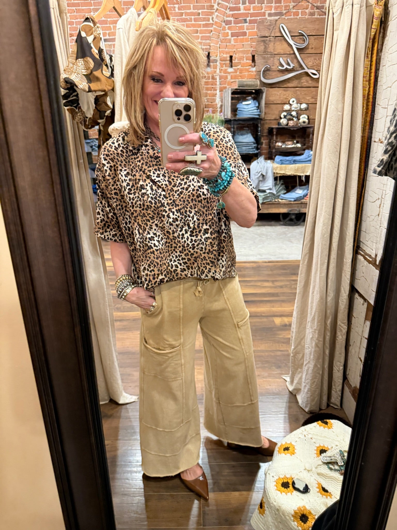 Lu wearing a leopard print top and beige pants in Springfield, MO boutique