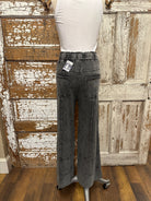 Mannequin wearing a white shirt and leisurewear pants against a rustic wooden background in Springfield, MO boutique