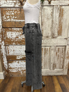 Mannequin wearing a white shirt and leisurewear pants against a rustic wooden background in Springfield, MO boutique