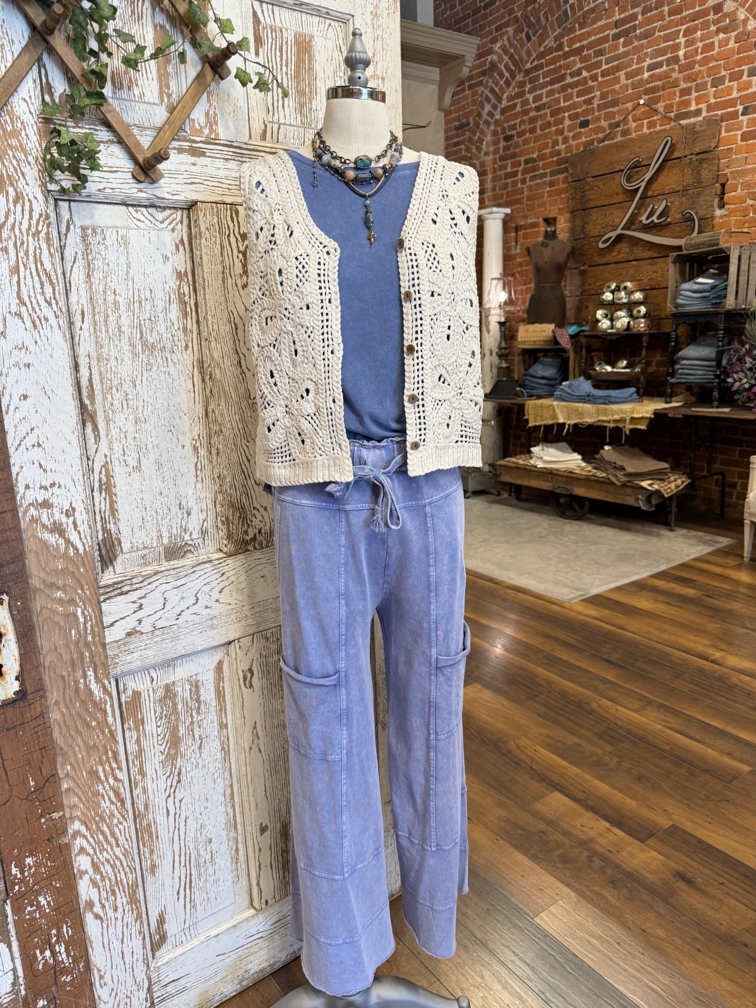 Mannequin in Leavenworth boutique store in leisurewear pants and crochet vest with handmade jewelry