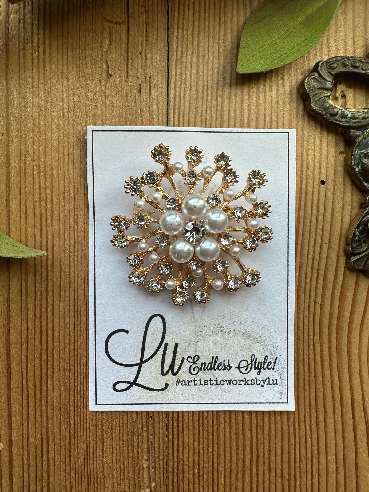 Gold-tone pearl and rhinestone starburst brooch