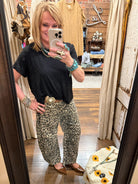 Lu wearing leopard print barrel pants and black top with turquoise jewelry in Leavenworth, KS boutique