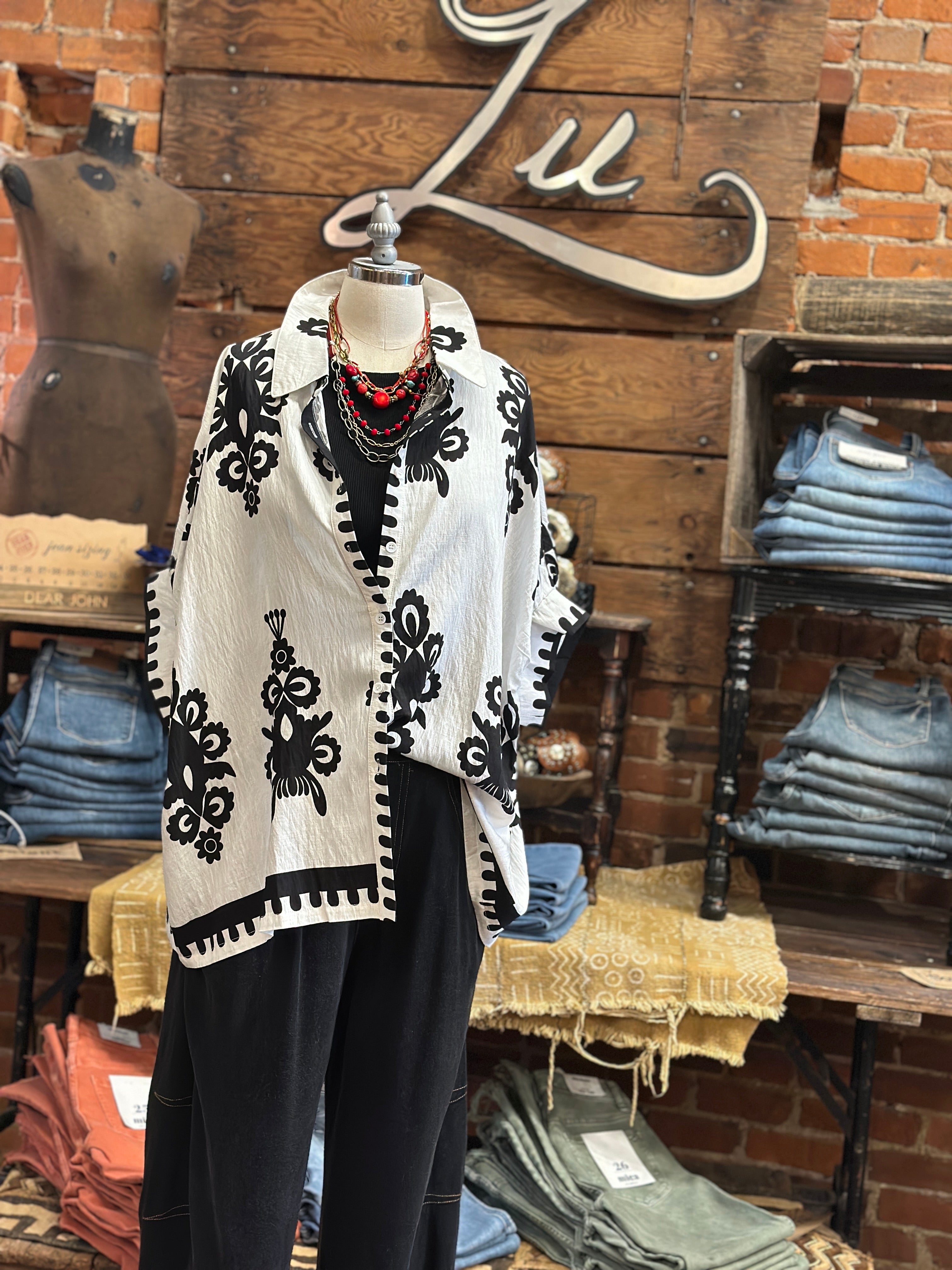 Mannequin wearing a black and white patterned top with jeans in Leavenworth, KS boutique