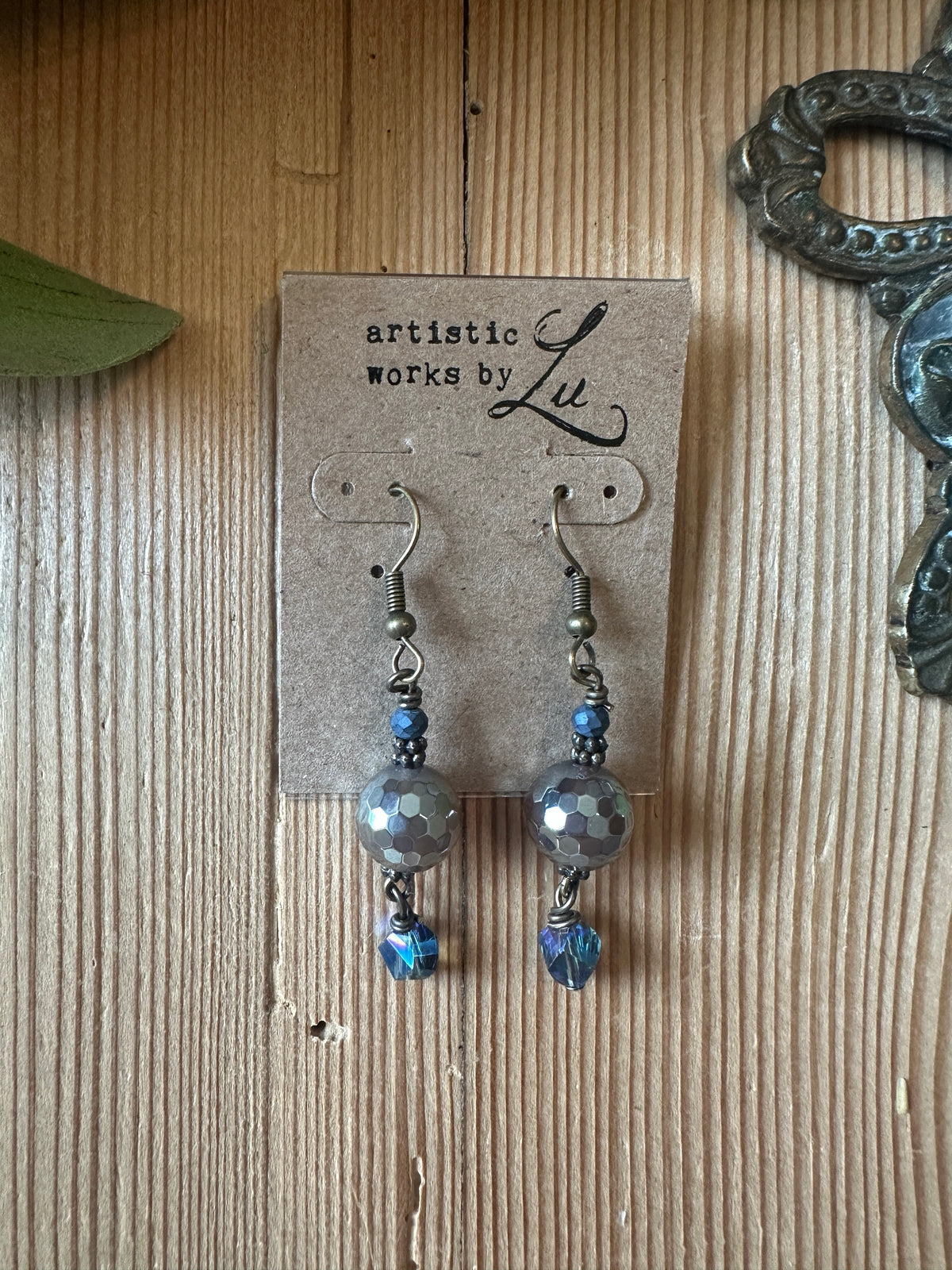Silver faceted bead dangle earrings with blue crystal accents