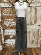 Mannequin wearing a white shirt and leisurewear pants against a rustic wooden background in Springfield, MO boutique