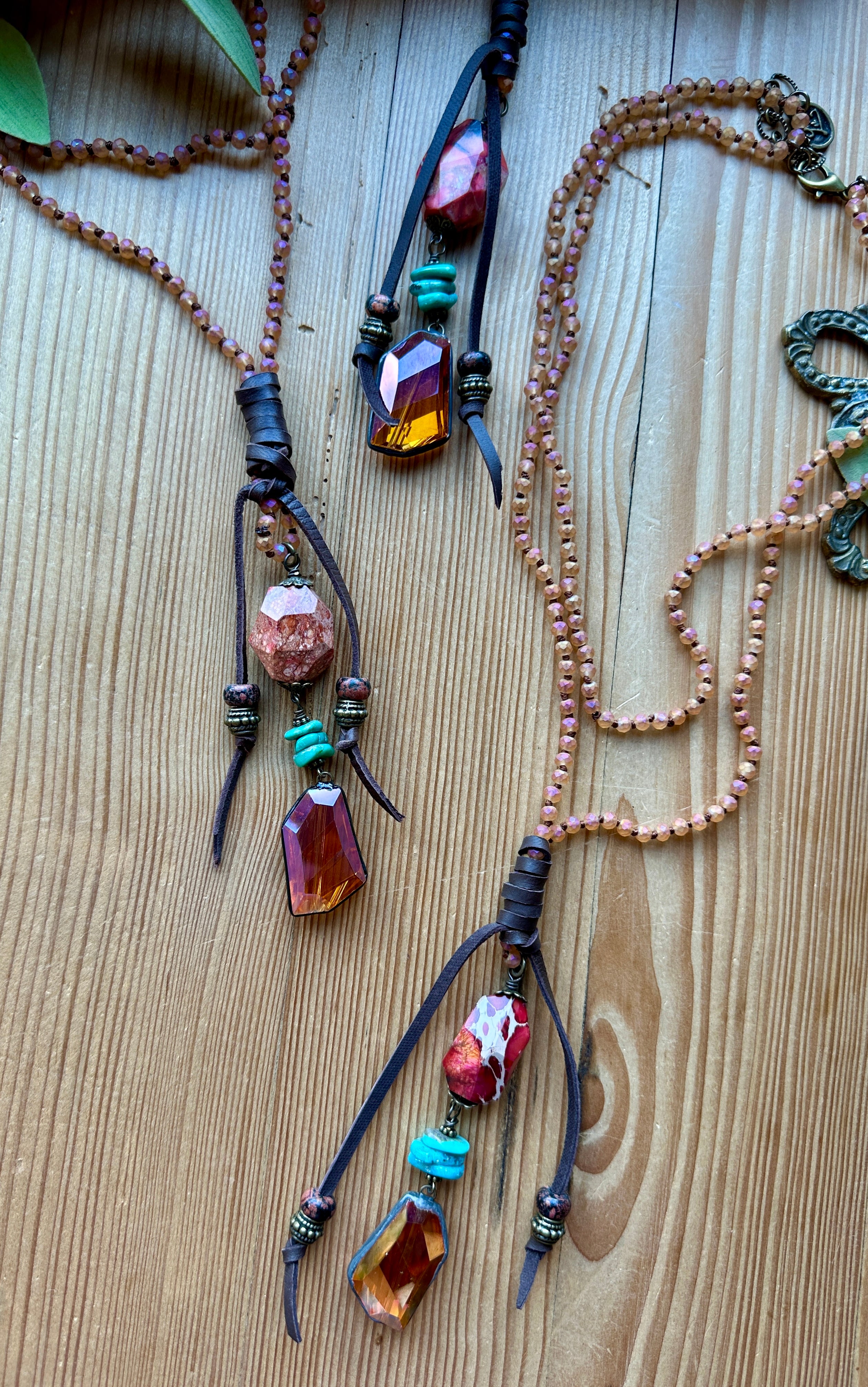 Two hand beaded necklaces with colorful beads on a wooden surface