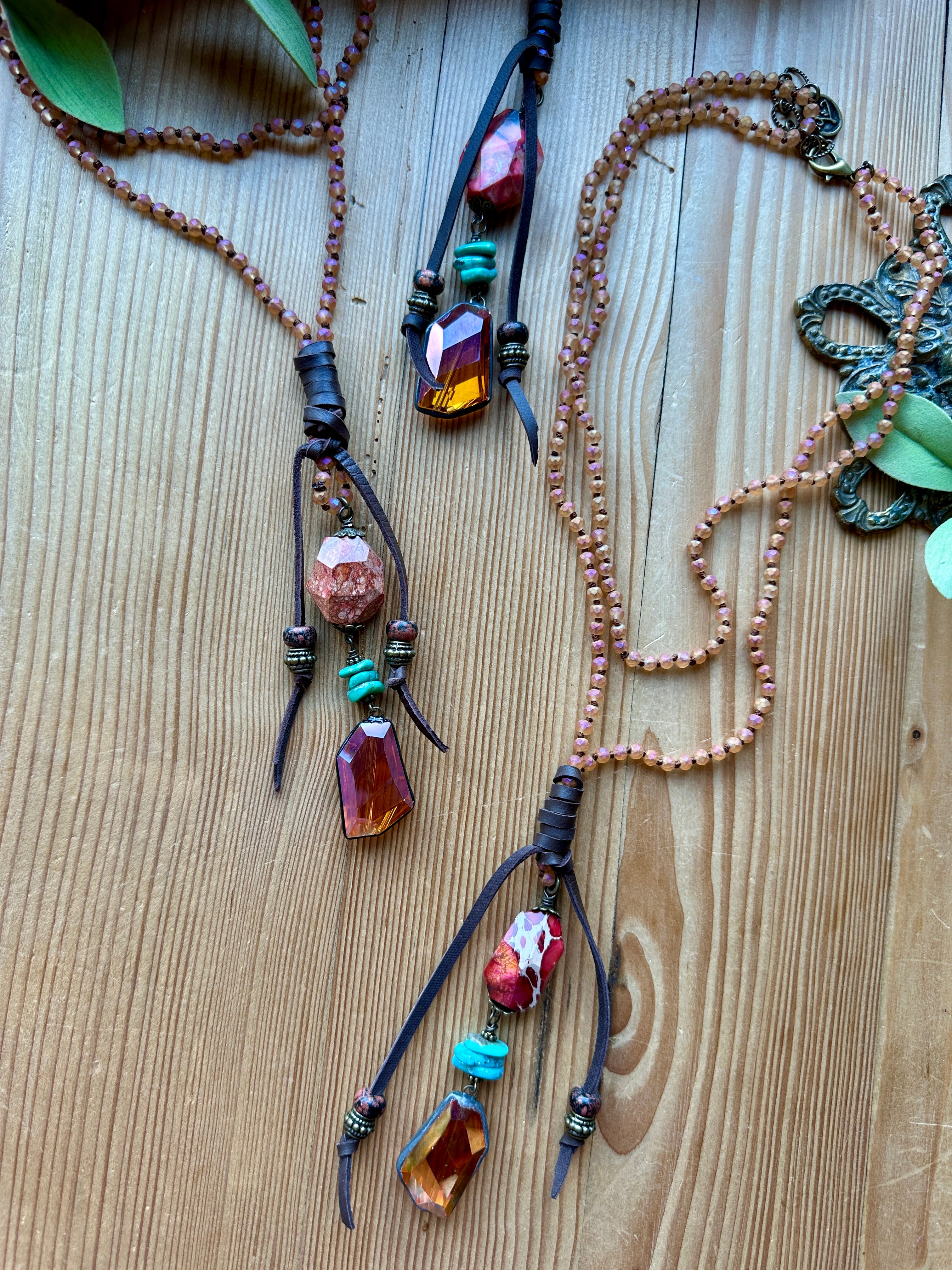 Two hand beaded necklaces with colorful beads on a wooden surface