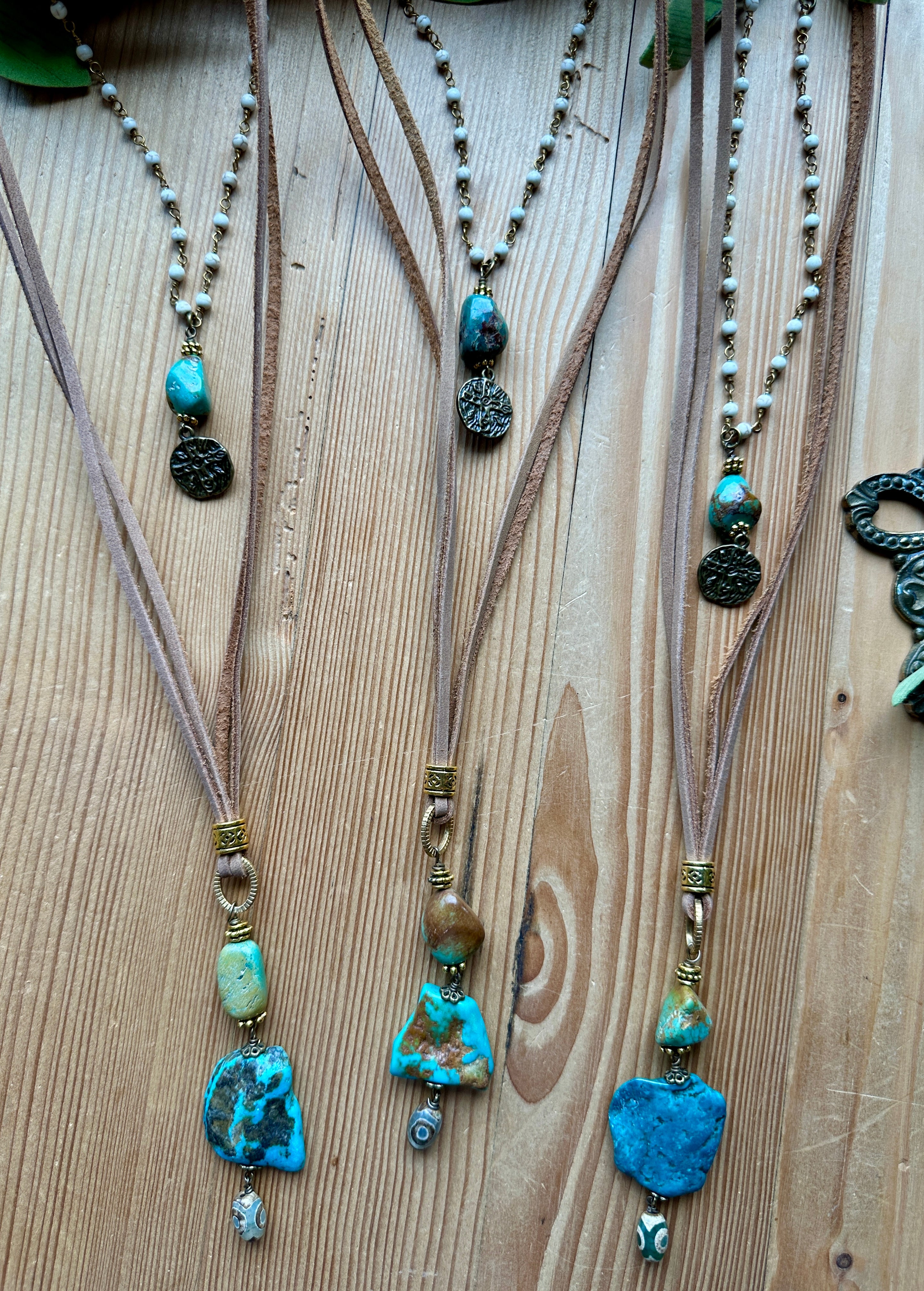 Handmade necklaces with turquoise beads on a wooden surface