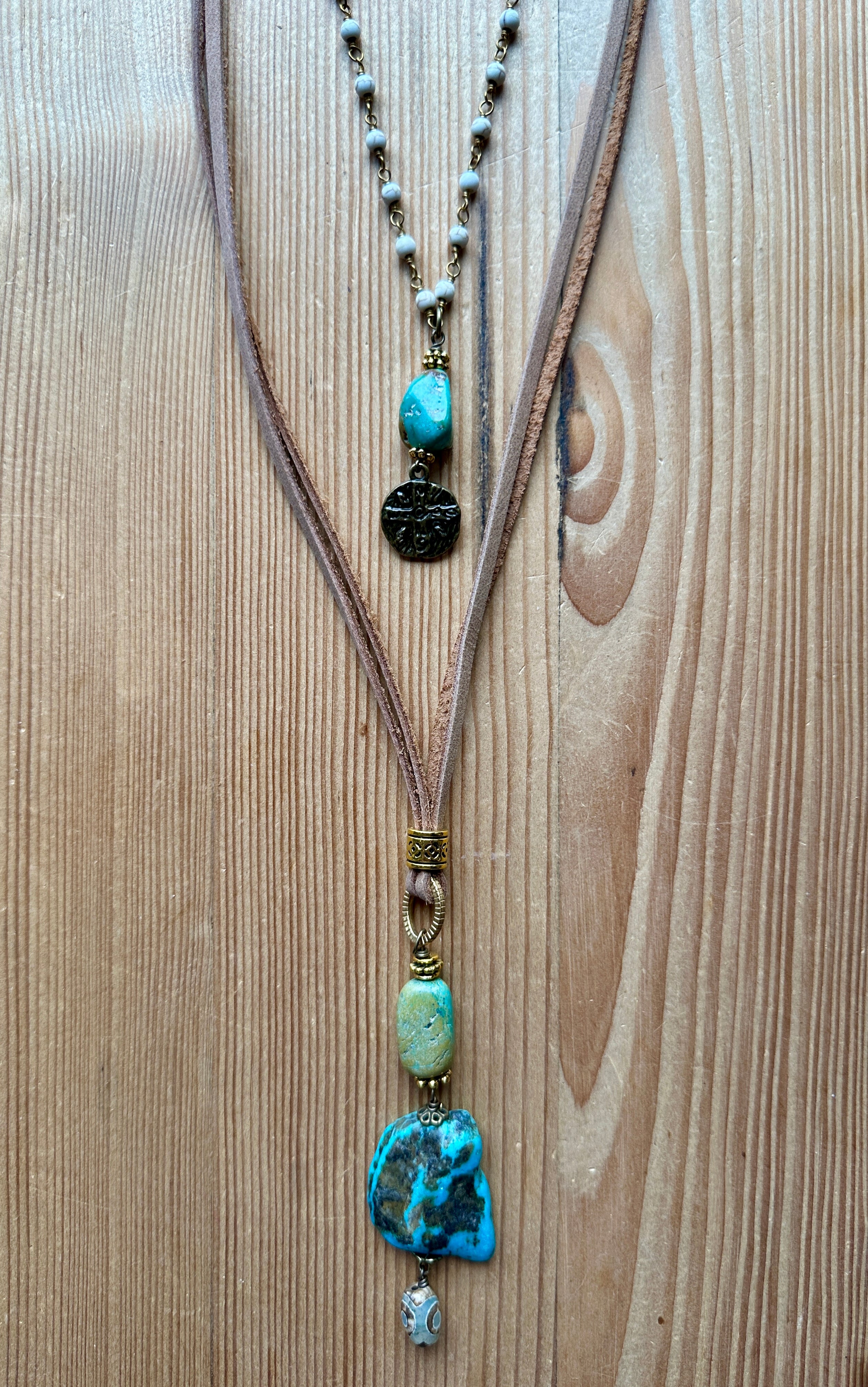 Handmade necklace with turquoise stones on a wooden surface