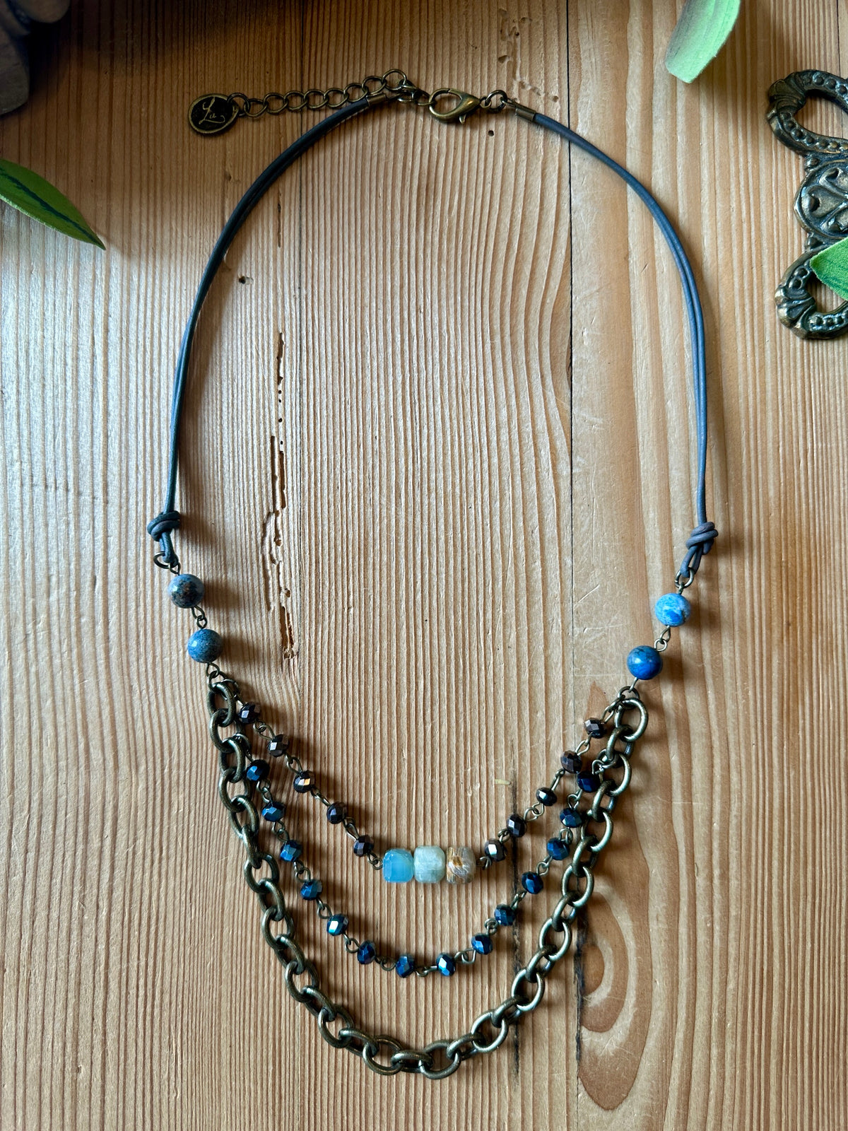 Layered brass chain necklace with blue stone and crystal beads