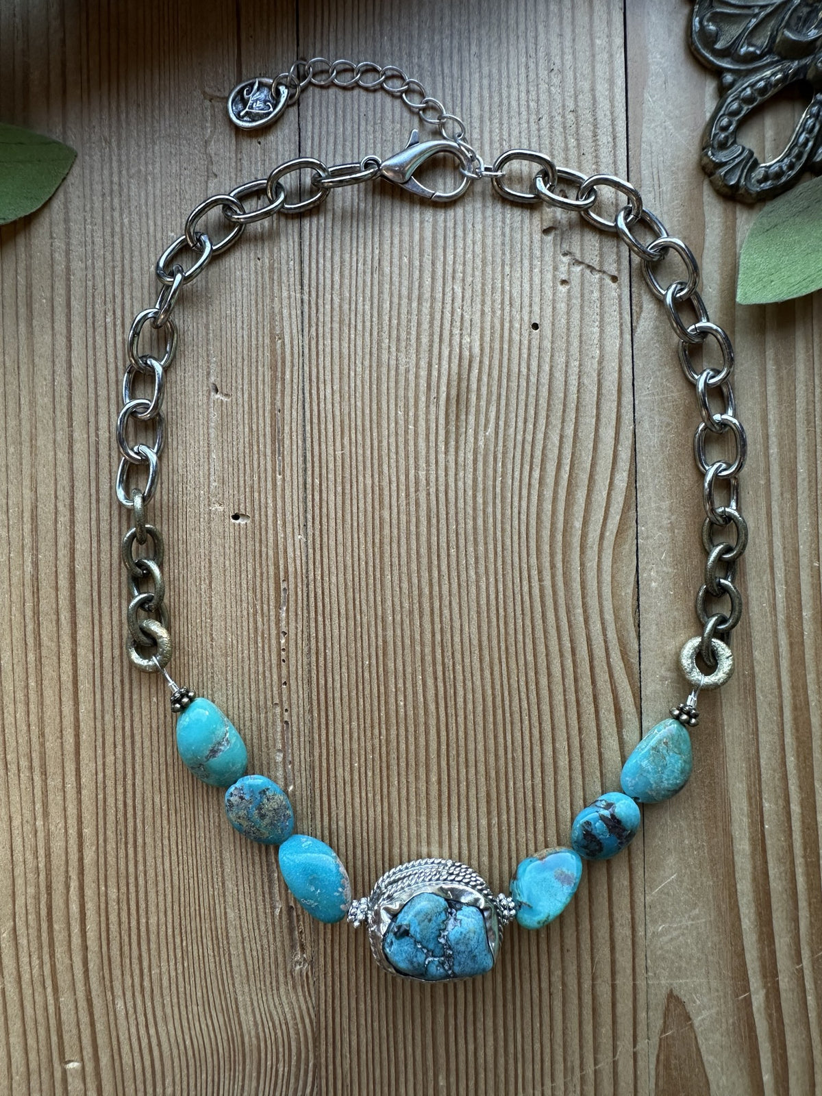 Sacred Ground Turquoise Nugget Necklace with seven turquoise nuggets, ornate silver-tone centerpiece, and mixed-metal chain