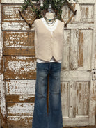 Mannequin wearing a boutique clothing vest white shirt and pants with handmade jewelry in Leavenworth, KS boutique