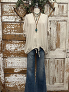 Mannequin wearing a boutique clothing top and jean pants with handmade jewelry designs in boutique near me 