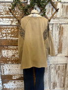 Mannequin wearing a star studded leopard top with leopard print accents and blue jeans in boutique leavenworth, ks