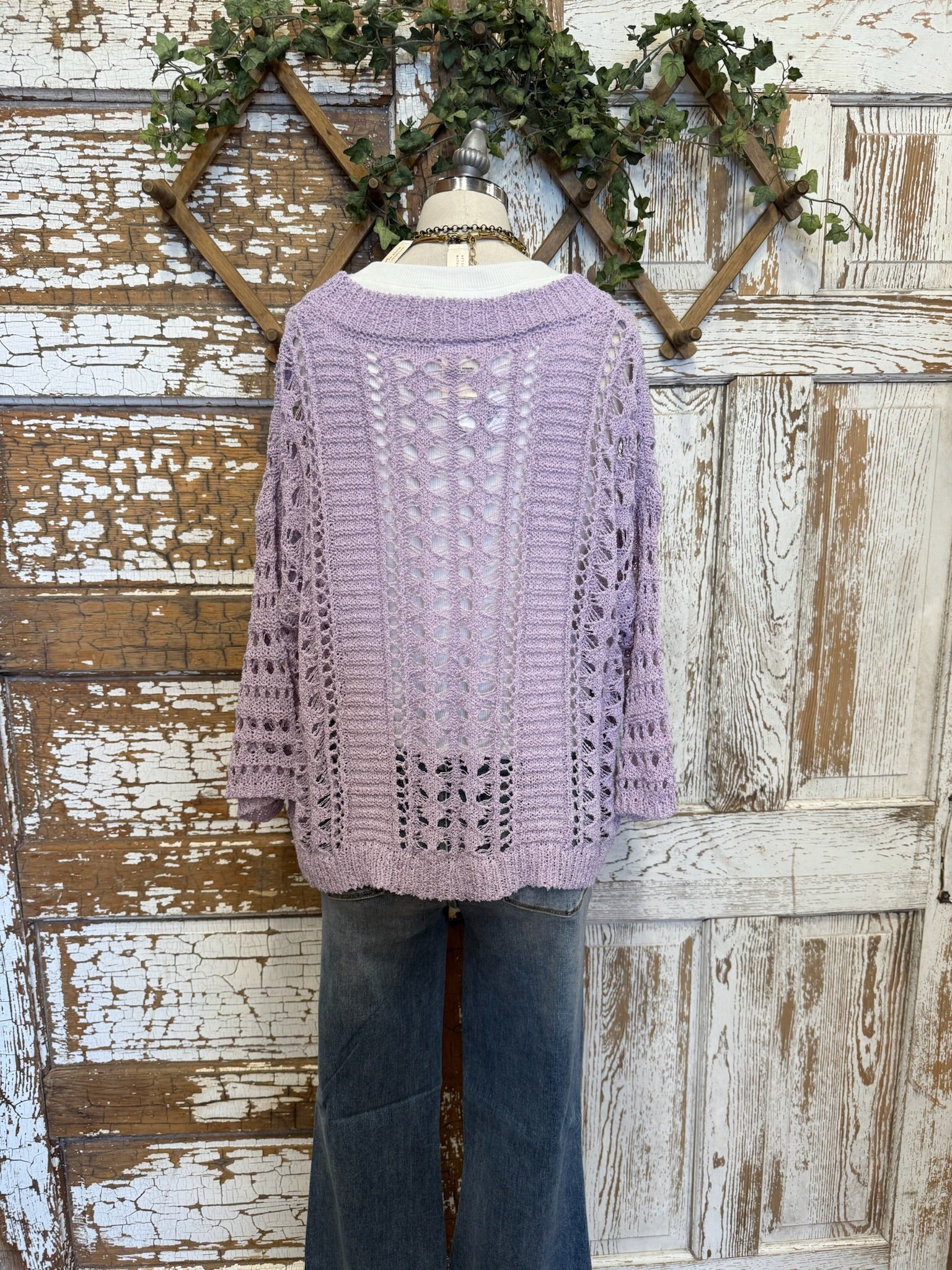 Lavender open knit sweater with handmade jewelry and jeans on mannequin 