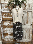 Mannequin wearing a boutique clothing top and camouflage pants with handmade jewelry designs in boutique near me 