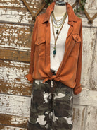 Mannequin wearing a boutique clothing jacket, white shirt, and camouflage pants with handmade jewelry in Leavenworth, KS boutique