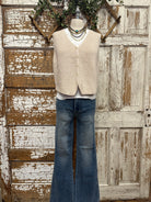 Mannequin wearing a boutique clothing vest white shirt and pants with handmade jewelry in Leavenworth, KS boutique