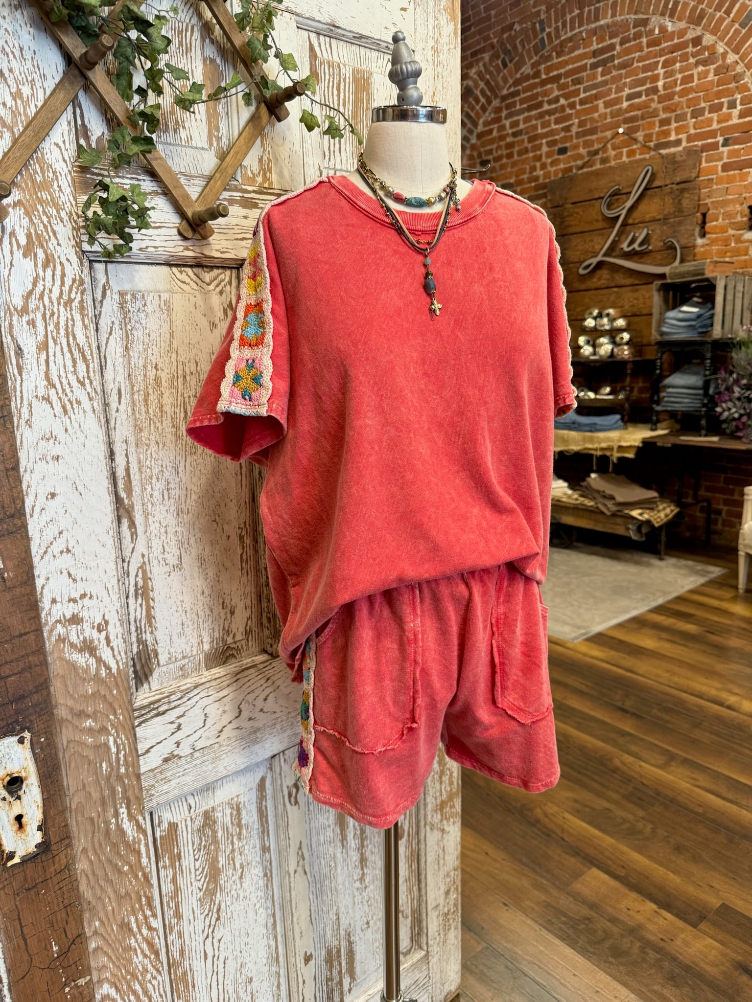 Mannequin wearing a poppy red matching leisure set in Leavenworth, KS boutique 