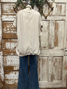 Mannequin wearing a boutique clothing top and camouflage pants with handmade jewelry designs in boutique near me 