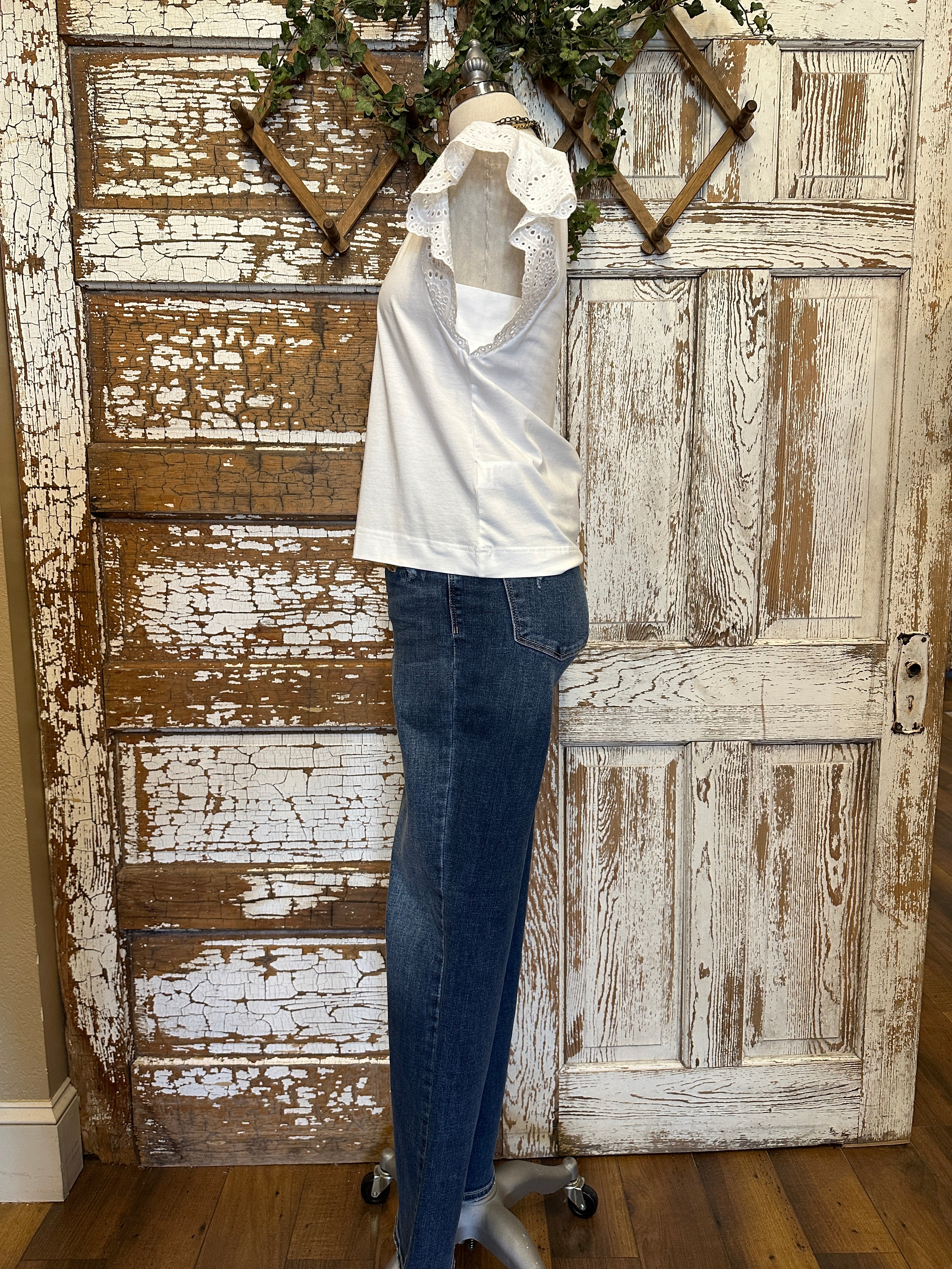 Mannequin wearing a white blouse with lace sleeves and layered handmade necklaces in Leavenworth, KS boutique setting