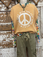 Mannequin wearing peace sign graphic tee in boutique Springfield, MO with handmade jewelry necklace