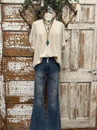 Mannequin wearing a boutique clothing top and camouflage pants with handmade jewelry designs in boutique near me 