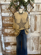 Mannequin wearing a star studded leopard top with leopard print accents and blue jeans in boutique leavenworth, ks