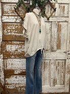 Mannequin wearing a boutique clothing top and camouflage pants with handmade jewelry designs in boutique near me 