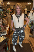 Lu standing in Leavenworth, KS boutique in new boutique clothing arrivals and handmade jewelry 