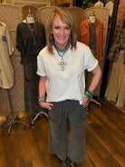 Lu standing in Leavenworth, KS boutique in new boutique clothing arrivals and handmade jewelry 