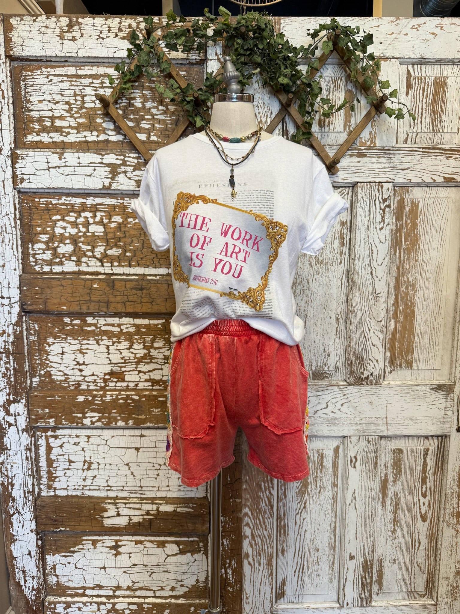 Mannequin wearing a poppy red matching leisure set with graphic tee in Leavenworth, KS boutique 