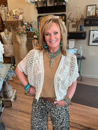 Lu wearing a toffee brown shirt with handmade turquoise jewelry and leopard print barrel jean pants in Lu's Leavenworth, KS boutique 