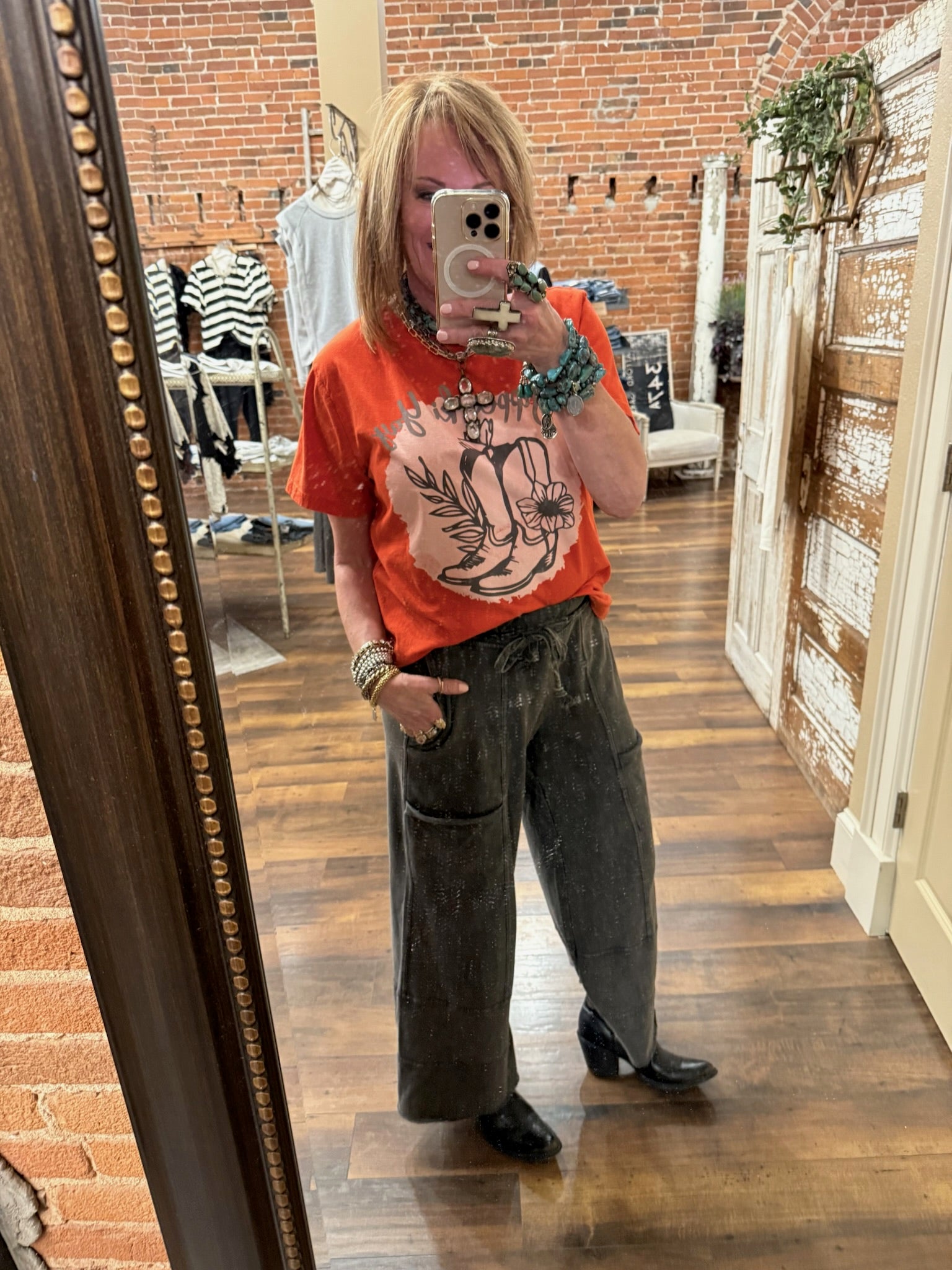 Lu standing in Leavenworth, KS boutique in new boutique clothing arrivals and handmade jewelry 