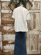 boutiques near me featuring white tee with jean pants and handmade jewelry 
