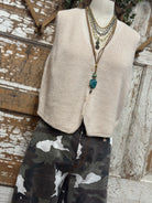 Mannequin wearing a boutique clothing vest white shirt and pants with handmade jewelry in Leavenworth, KS boutique