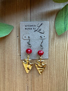 Gold arrowhead dangle earrings with faceted red crystal beads on an Artistic Works By Lu earring card