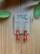 Red enamel and gold paperclip chain drop earrings on an Artistic Works By Lu earring card