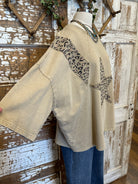 Mannequin wearing a star studded leopard top with leopard print accents and blue jeans in boutique leavenworth, ks