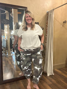 Lu standing in Leavenworth, KS boutique in new boutique clothing arrivals and handmade jewelry 