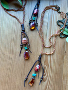 Two hand beaded necklaces with colorful beads on a wooden surface