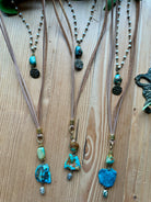 Handmade necklaces with turquoise beads on a wooden surface