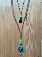 Handmade necklace with turquoise stones on a wooden surface