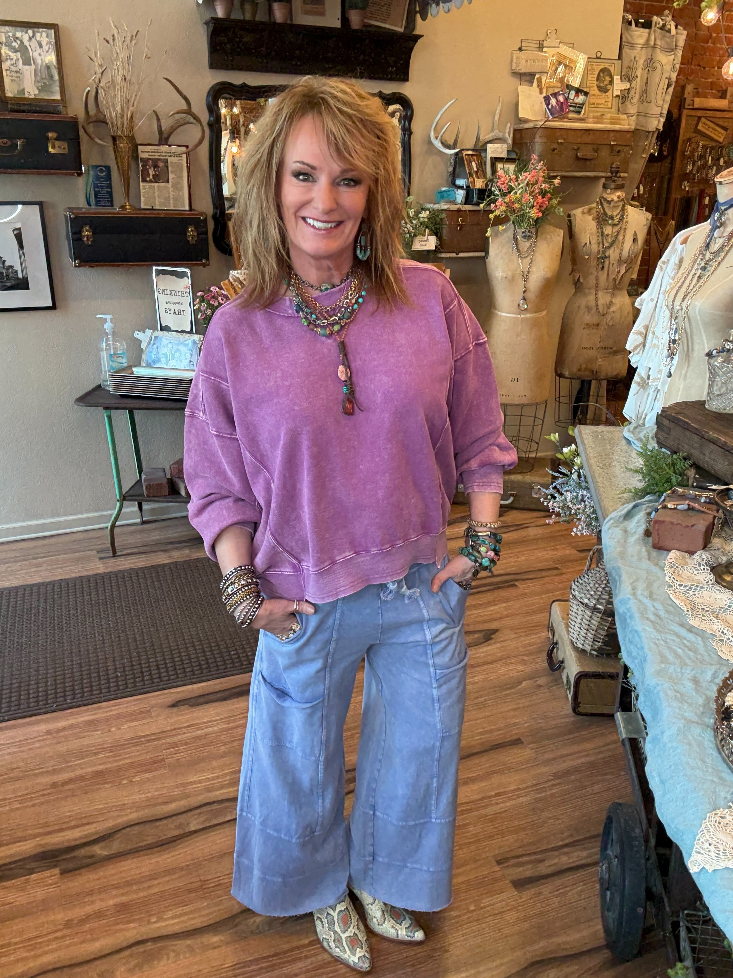 Lu wearing a purple sweater and periwinkle loungewear and leisurewear pants in Leavenworth, KS clothing boutique