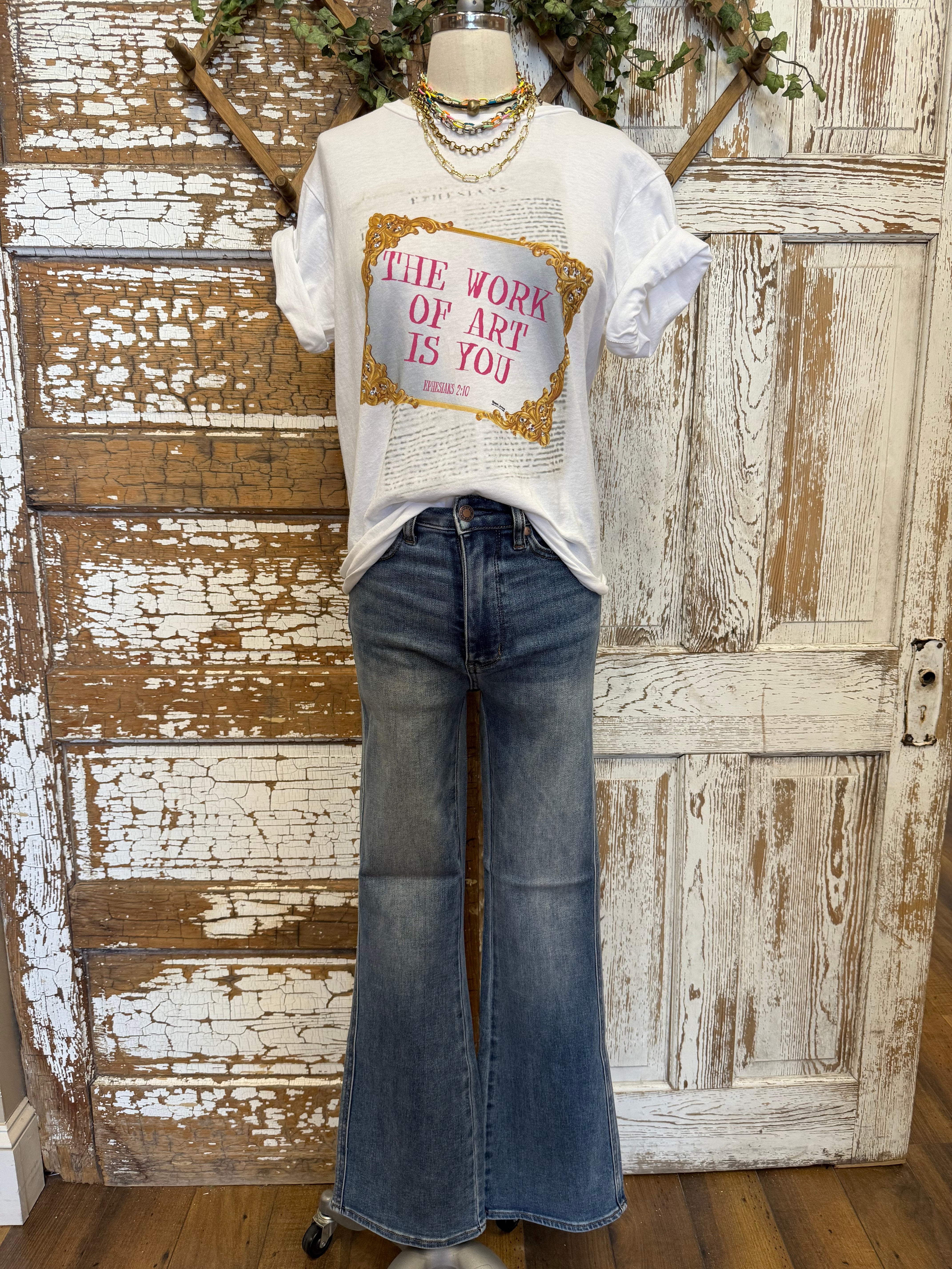 Mannequin wearing graphic tee and jeans 
