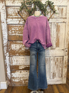 Mannequin wearing a purple sweatshirt and blue jeans in Springfield, MO boutique