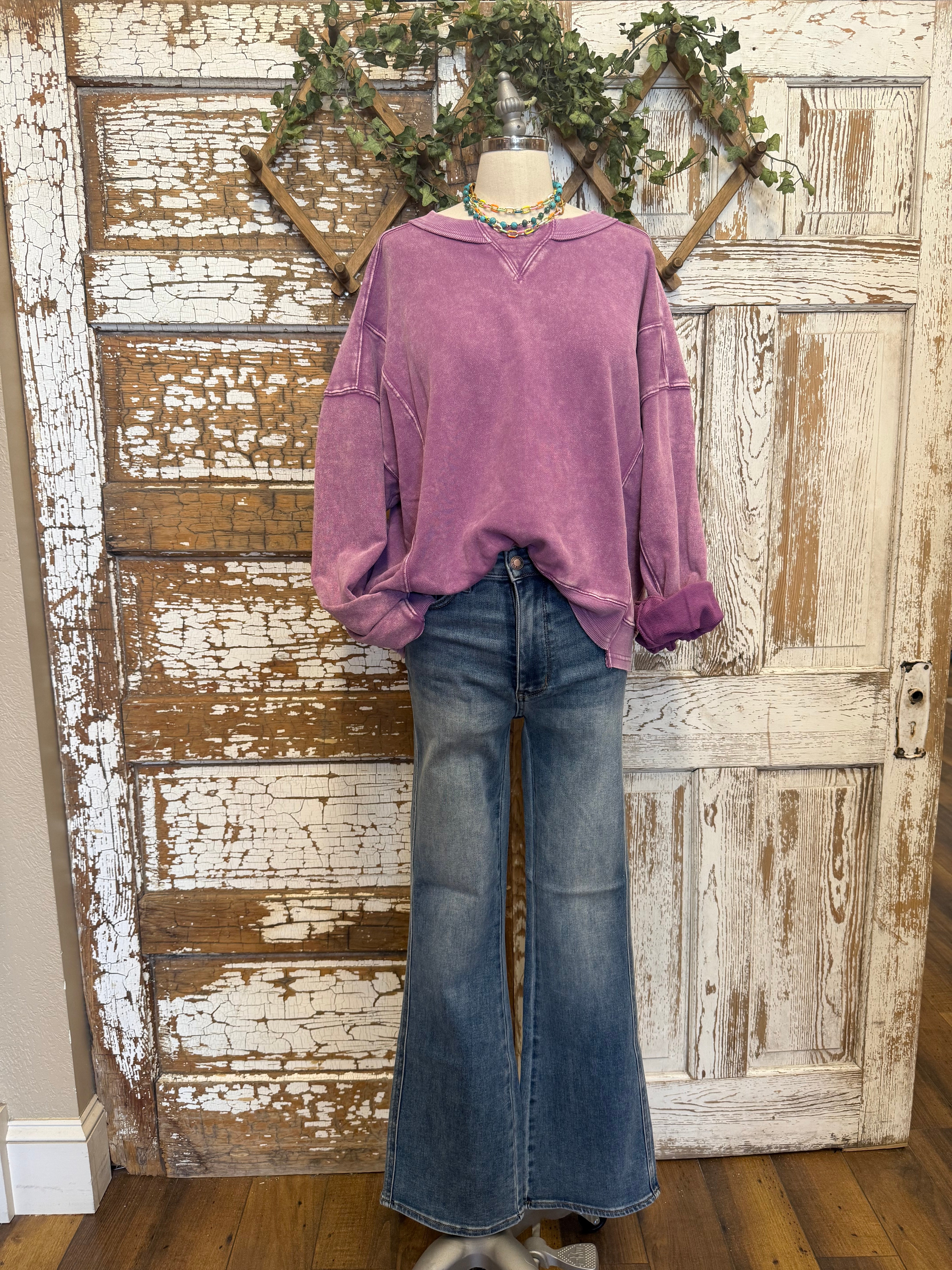 Mannequin wearing a purple sweatshirt and blue jeans in Springfield, MO boutique
