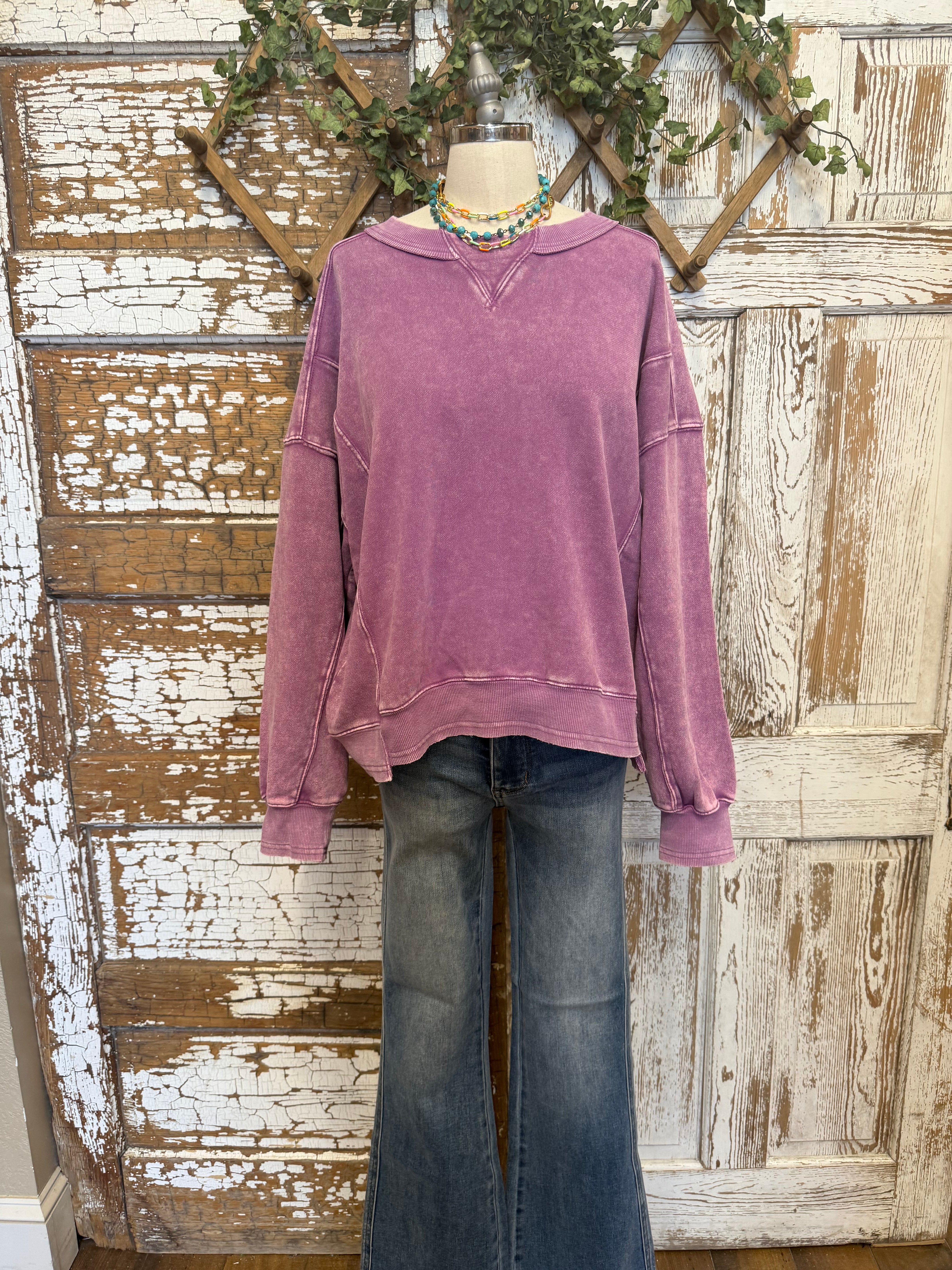 Mannequin wearing a purple sweatshirt and blue jeans in Springfield, MO boutique