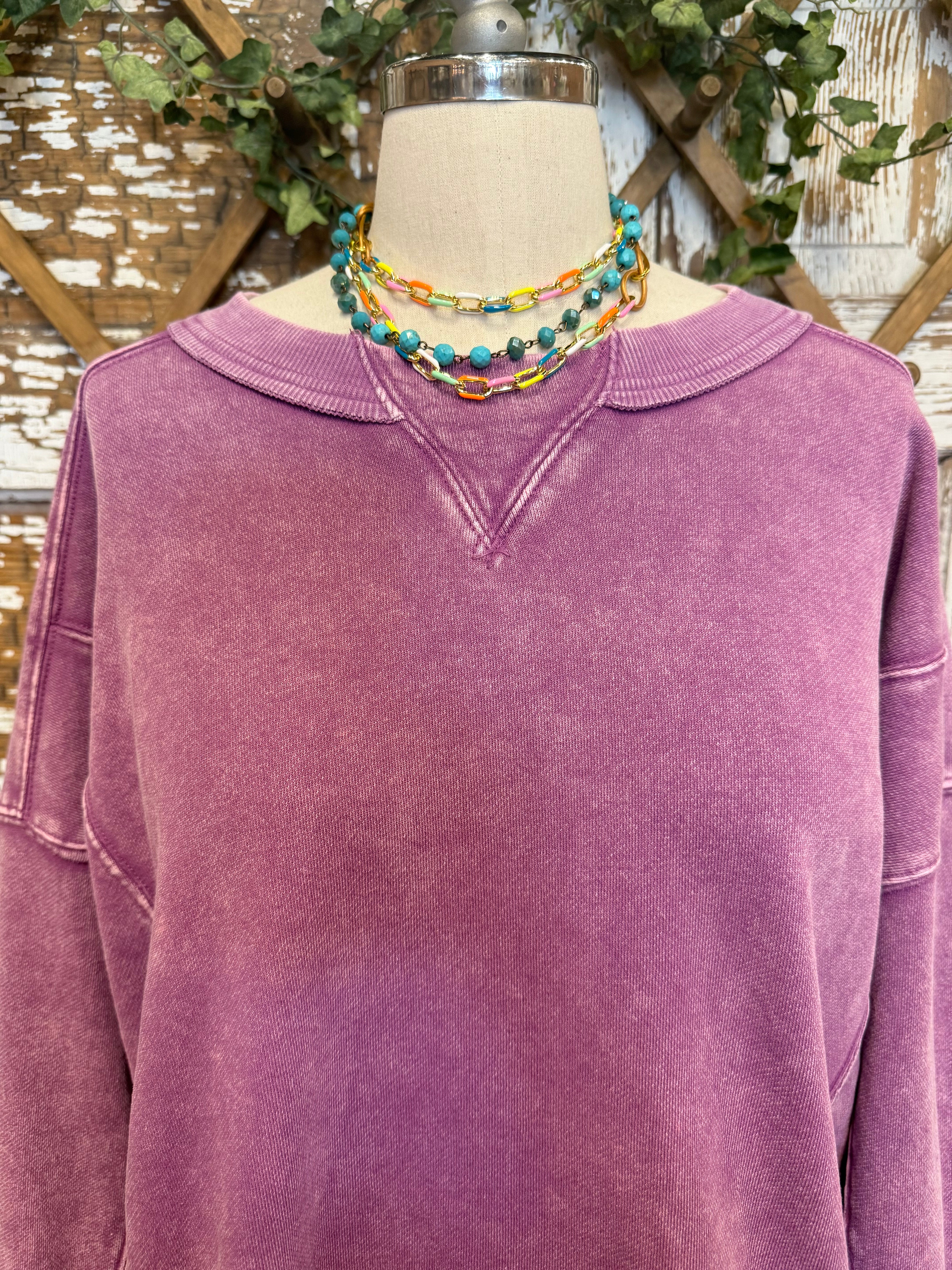 Mannequin wearing a purple sweatshirt and blue jeans in Springfield, MO boutique