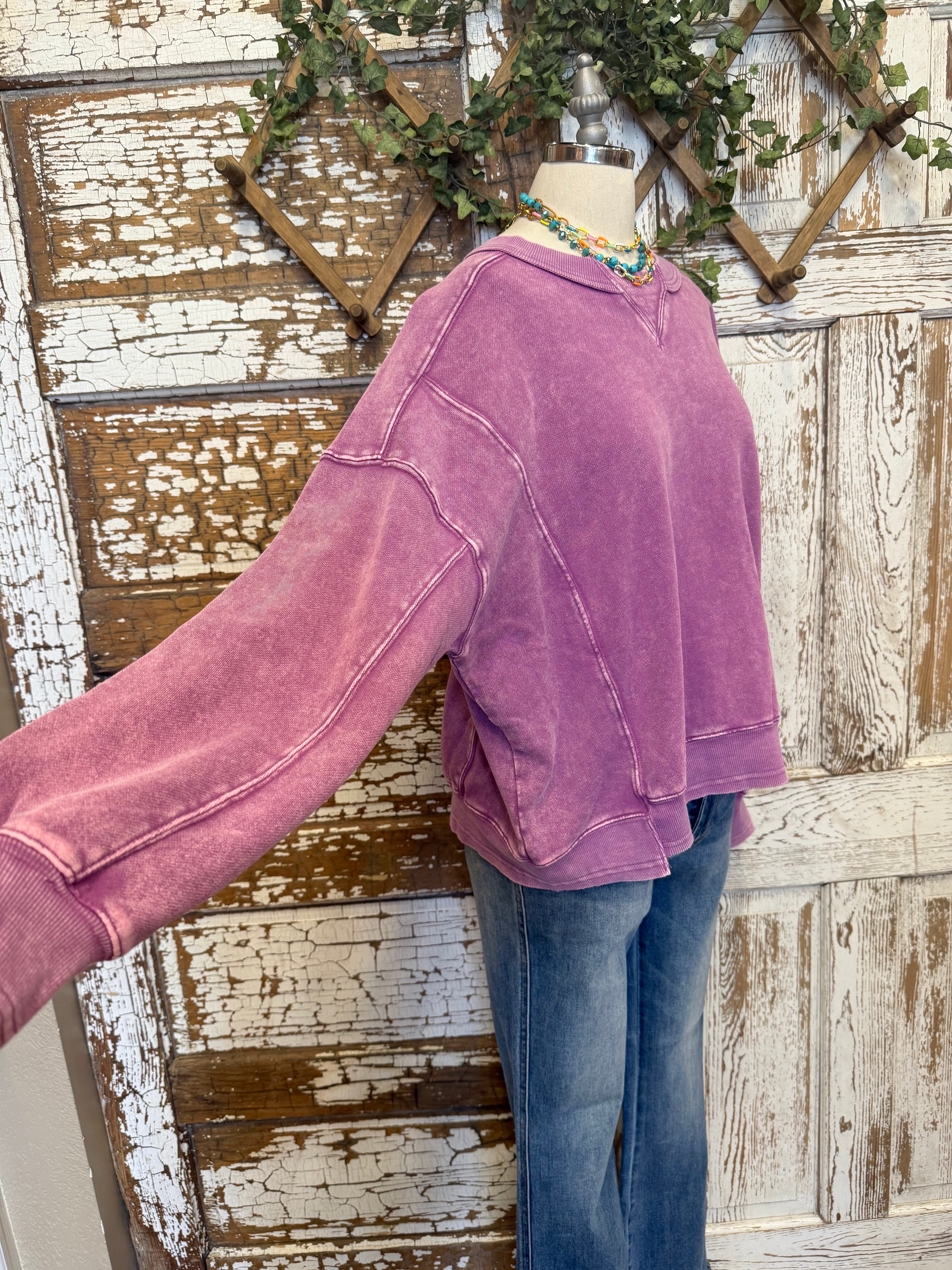 Mannequin wearing a purple sweatshirt and blue jeans in Springfield, MO boutique